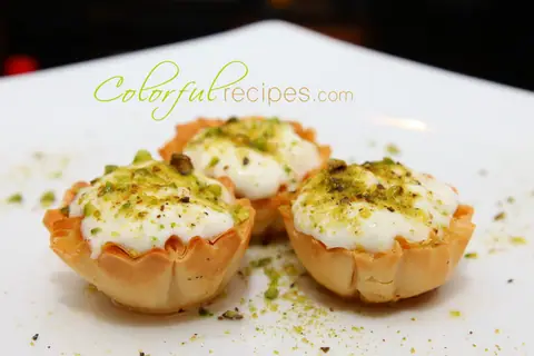 Phyllo ashta shells filled with Lebanese cream and topped with ground pistachios