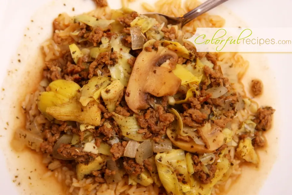 Close-up of artichoke mushroom beef stew with sliced mushrooms and quartered artichoke hearts
