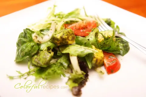 Avocado greens salad with mixed greens, sliced tomatoes, onion and diced avocado