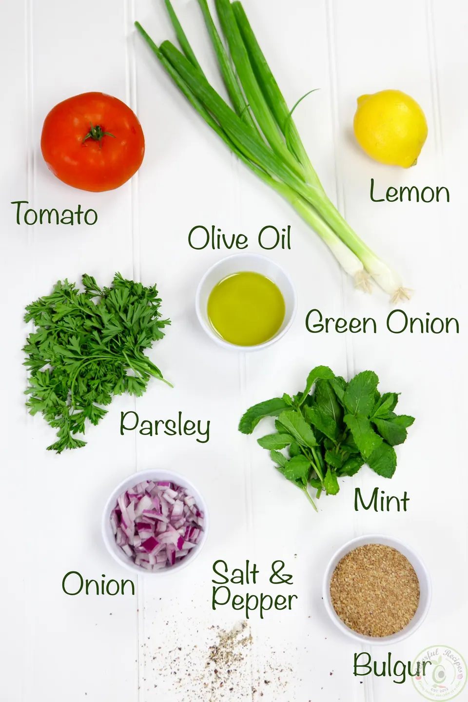 Labeled ingredients for Lebanese tabbouleh: parsley, mint, tomato, onions, lemon, olive oil and bulgur
