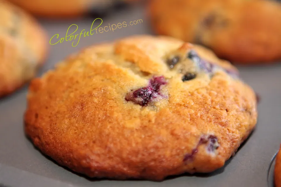 Close-up of a golden banana blueberry muffin studded with blueberries