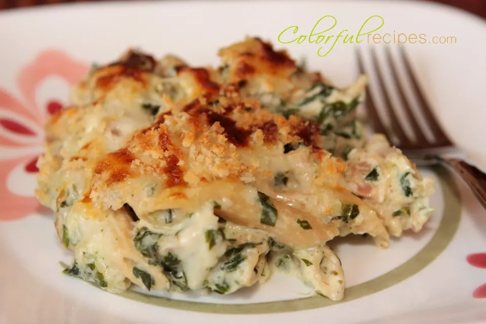 Serving of spinach chicken penne bake with a golden panko and cheese topping