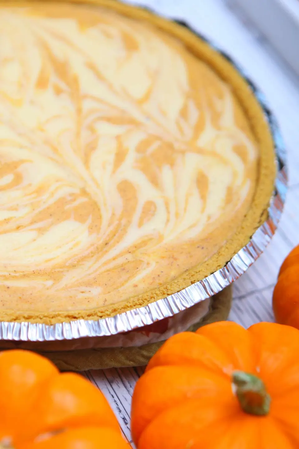 Cheesecake pumpkin swirl pie in a graham cracker crust
