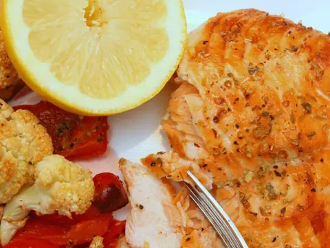 Lemon cedar planked salmon fillet grilled on lemon slices