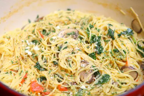 One pot kale mushroom pasta with tomatoes and spaghetti in a Dutch oven