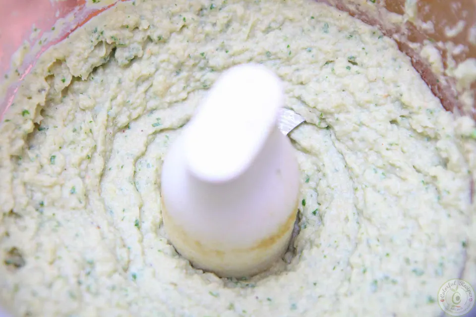 Blended cilantro white bean artichoke dip in the food processor bowl