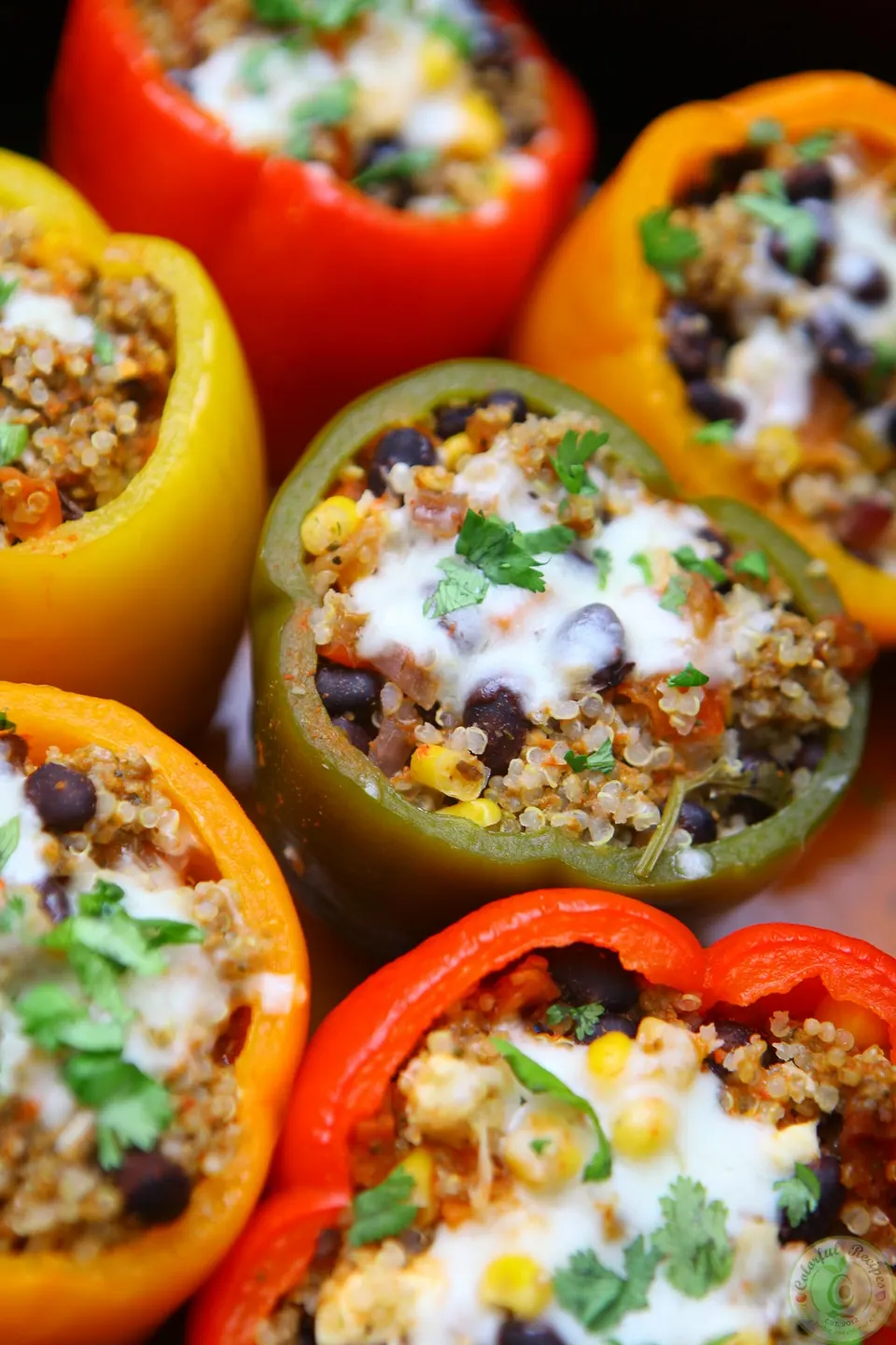 Colorful crockpot stuffed peppers with quinoa, black beans and cheese