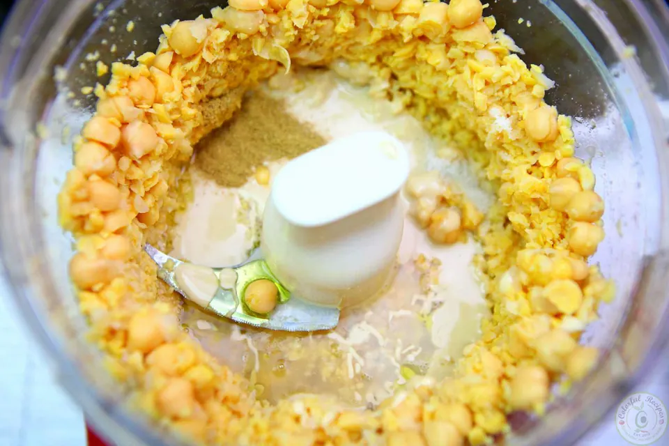 Creamy homemade hummus drizzled with olive oil in a serving bowl
