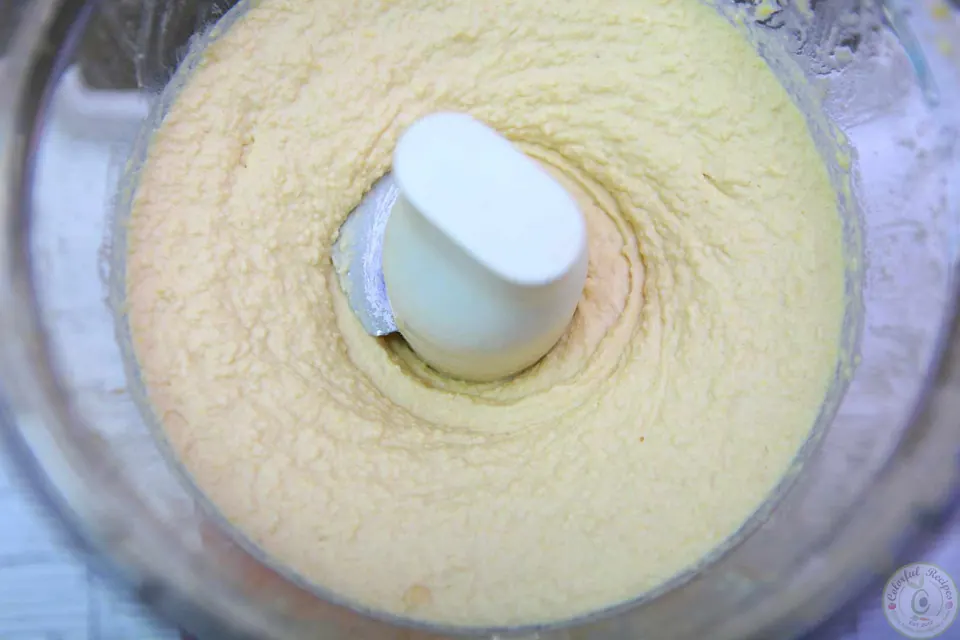 Close-up of 5 minute creamy hummus garnished with chickpeas and chopped parsley