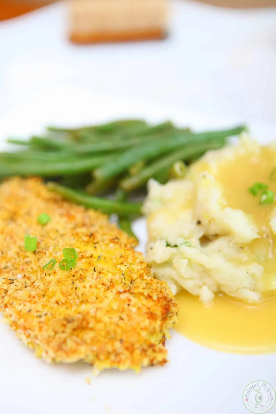 Italian oven fried crispy chicken breast with mashed potatoes, gravy and green beans