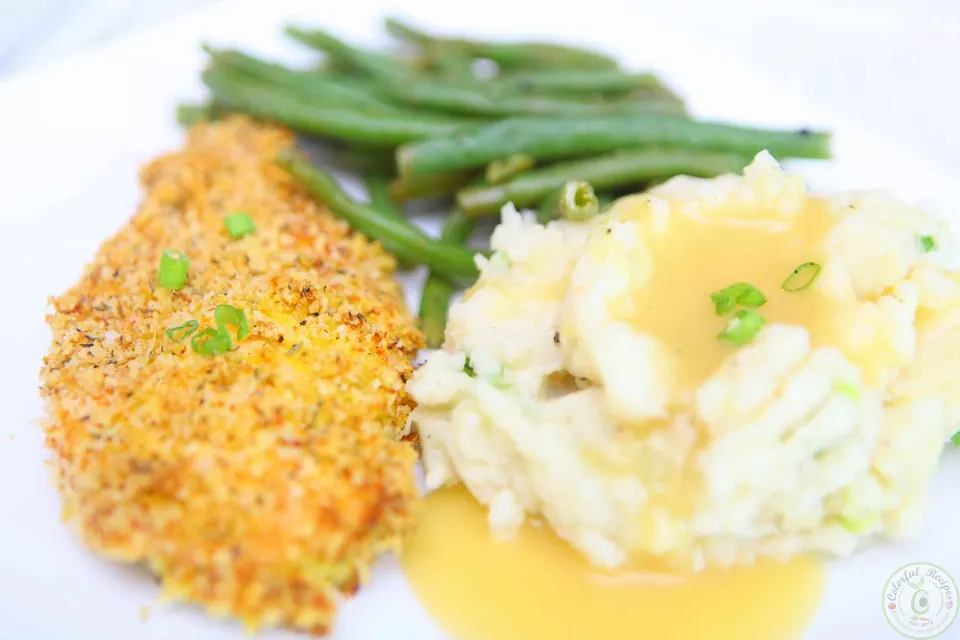 Crispy Italian oven fried chicken served with mashed potatoes and green beans