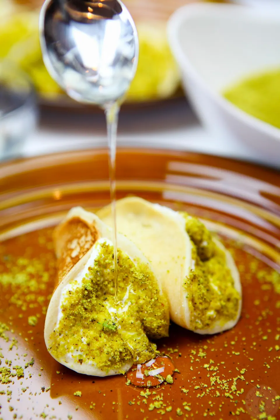 Plate of Lebanese ricotta stuffed atayef drizzled with orange blossom syrup