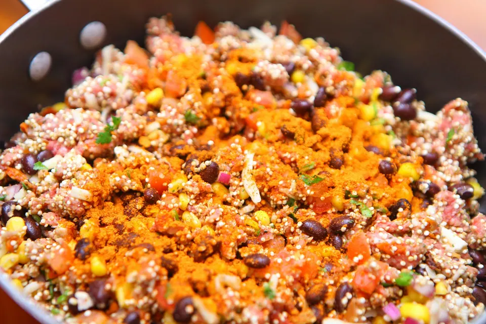 Beef, quinoa and black bean taco filling with taco seasoning in a deep pan