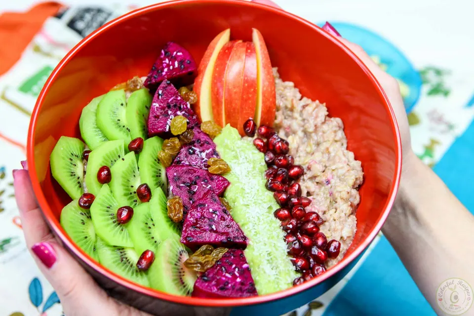 Two exotic fruit oatmeal bowls with avocado banana cream and fresh fruit