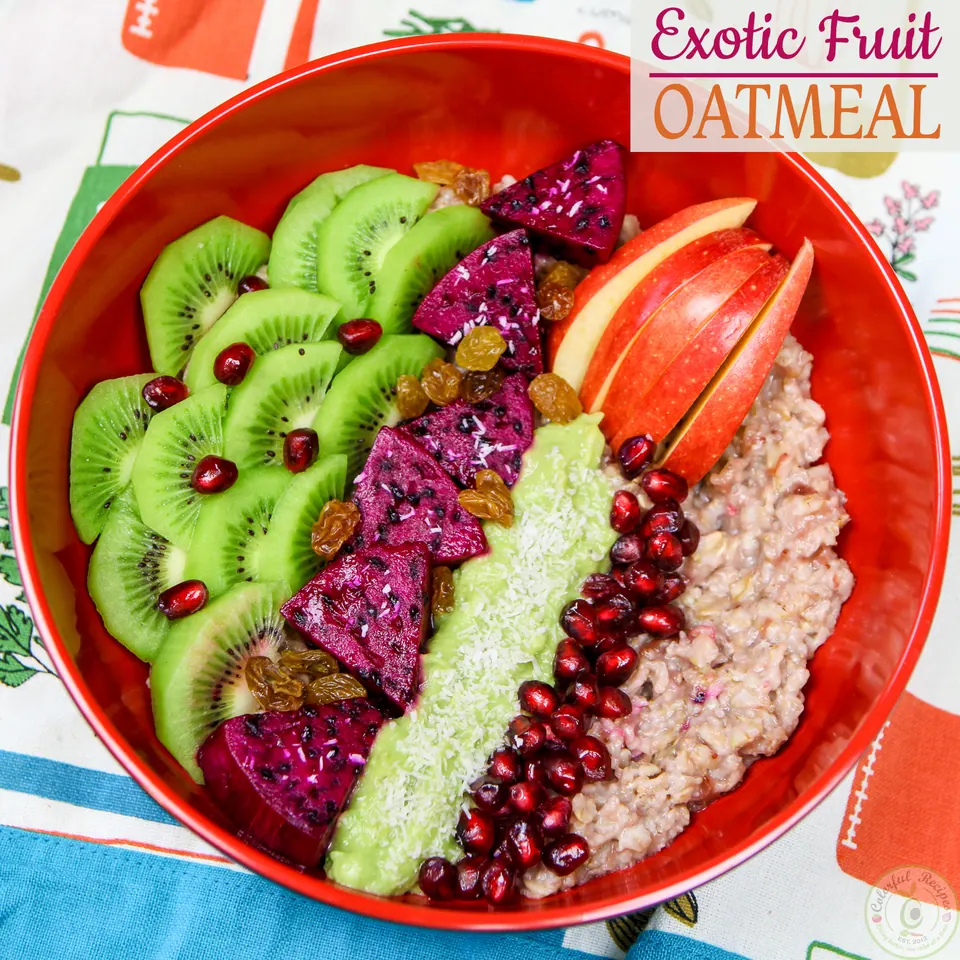 Exotic fruit oatmeal bowl with sliced kiwi, apple and dragon fruit shapes