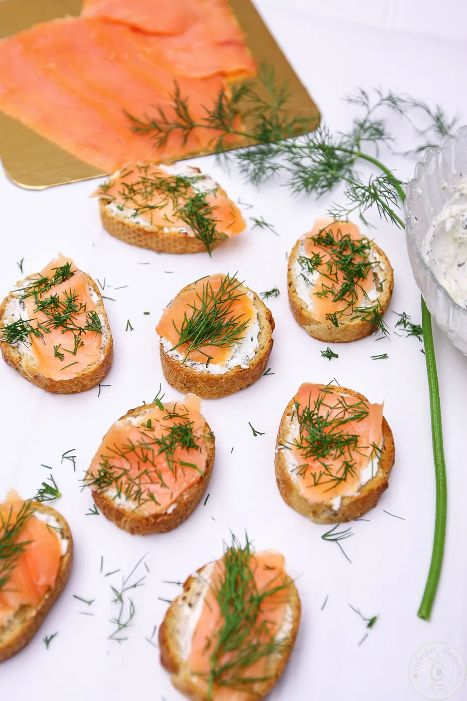 Smoked salmon dill goat cheese baguette bites on parchment paper