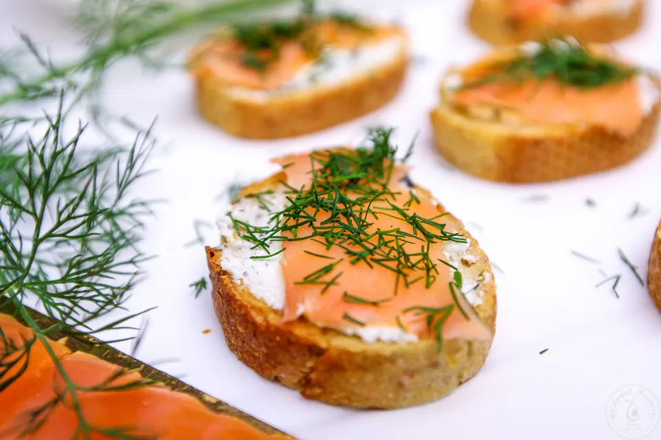 Smoked salmon baguette bites garnished with fresh dill