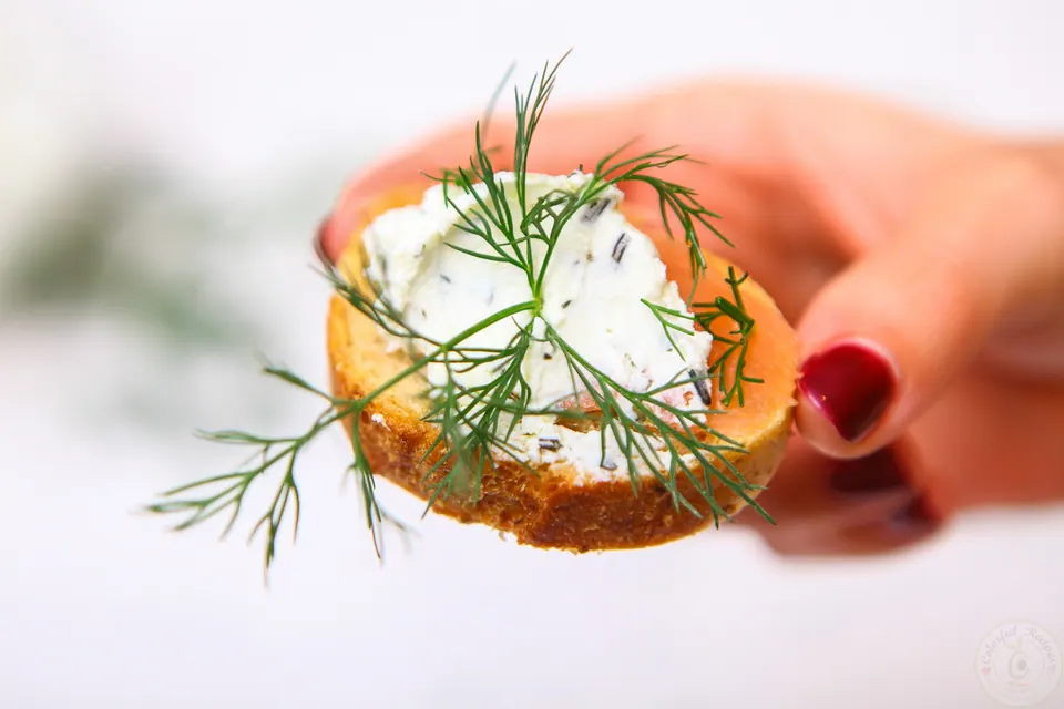Smoked salmon dill goat cheese baguette bites surrounded by dill sprigs