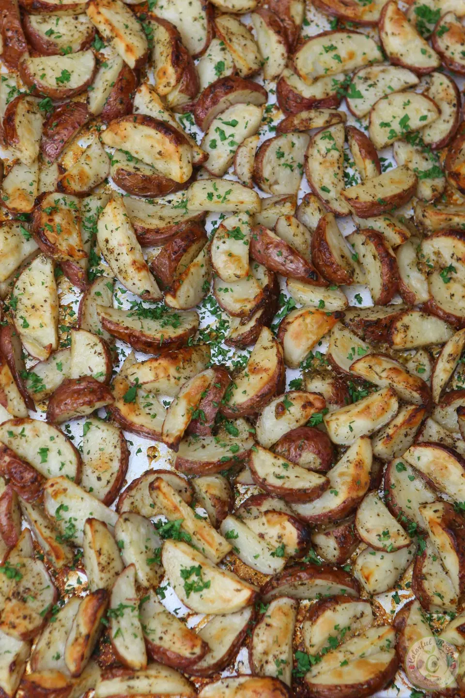 Golden Italian ranch roasted red potatoes on a baking sheet