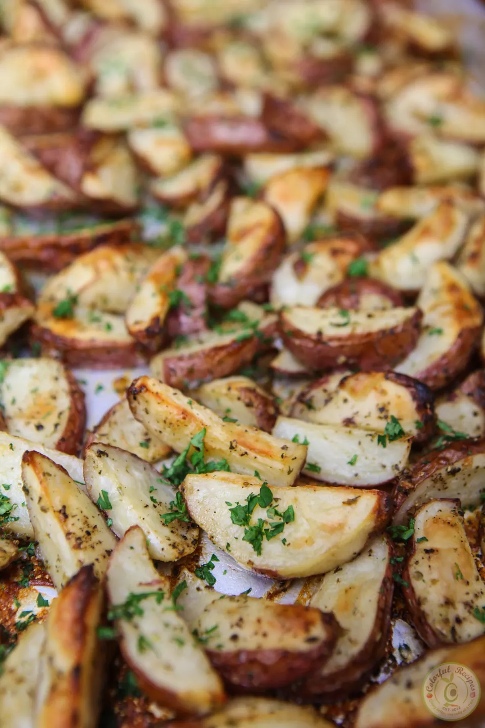 Bowl of Italian ranch roasted red potatoes garnished with parsley