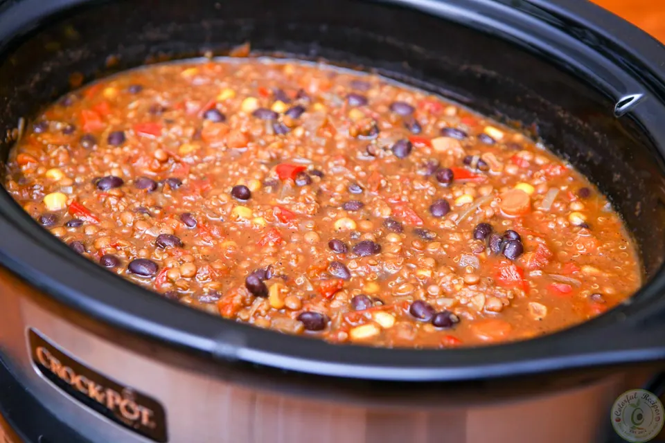 Thick cooked black bean lentil quinoa chili in a Crock Pot
