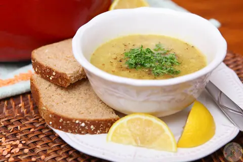 Bowl of Shorbet Adas Mediterranean red lentil soup with parsley and lemon