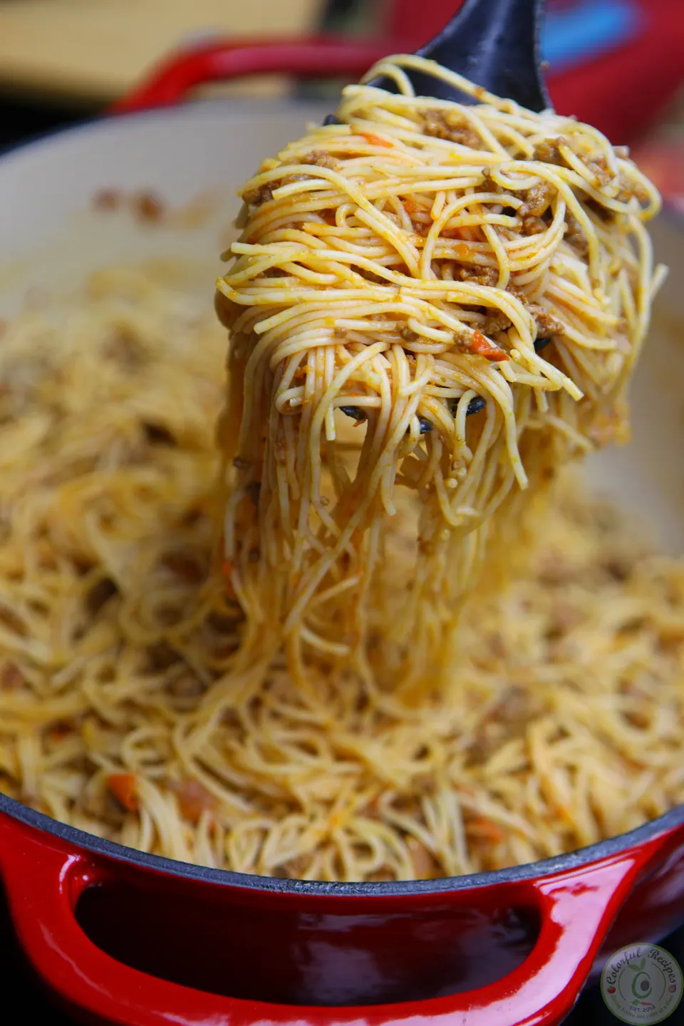 Cooked spaghetti tossed in beef tomato sauce