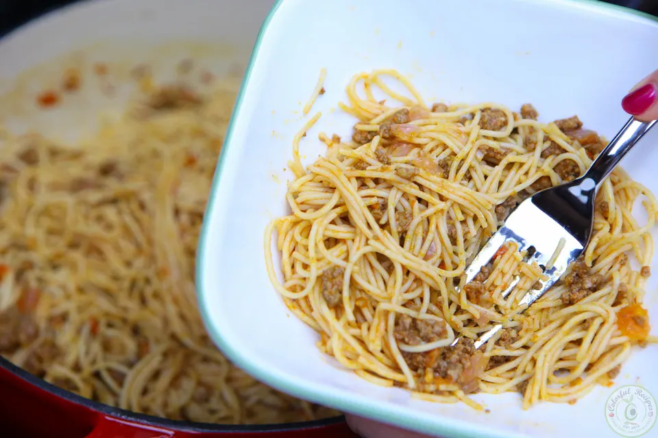 Simple beef spaghetti mashed with a fork for a baby