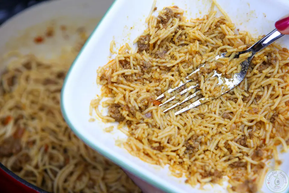 Toddler-sized bowl of simple beef spaghetti with a spoon