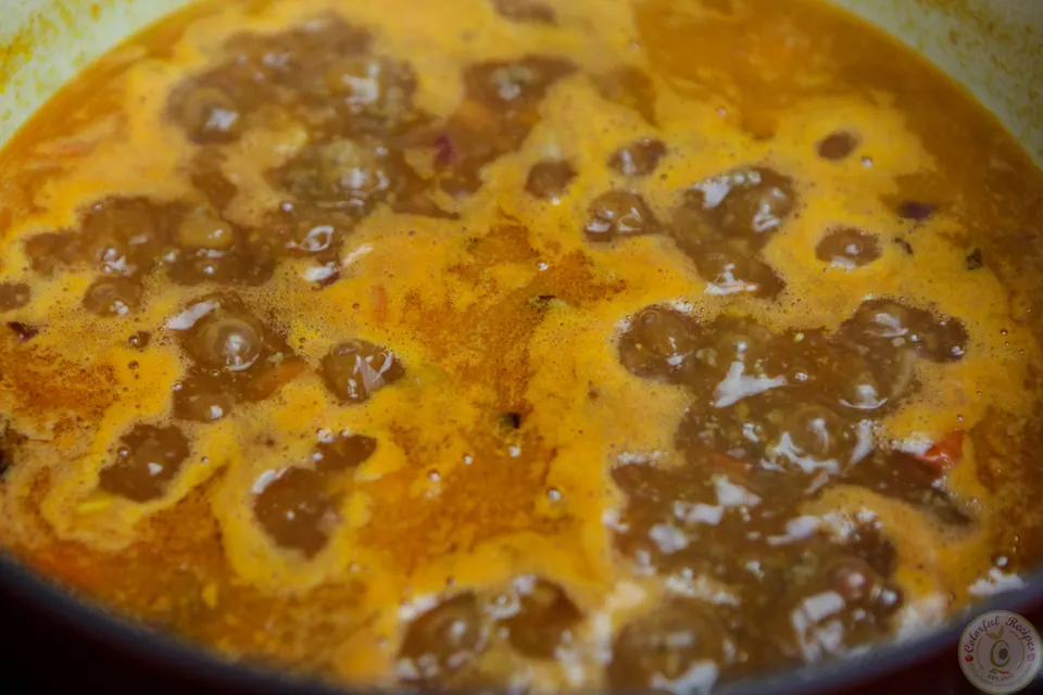 Simple beef spaghetti sauce simmering in a Dutch oven