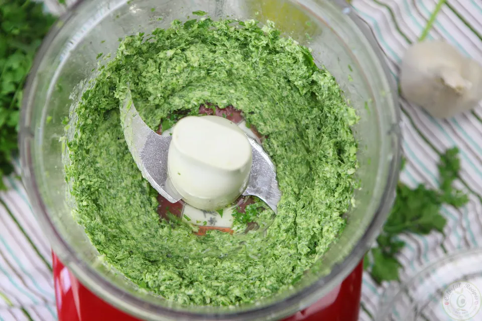 Blended cilantro garlic citrus butter in a food processor