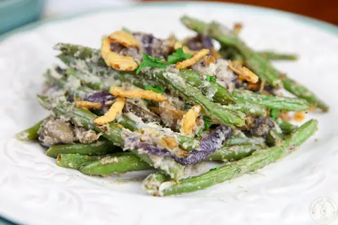 Serving of cashew cream green bean casserole with mushrooms and crispy onions