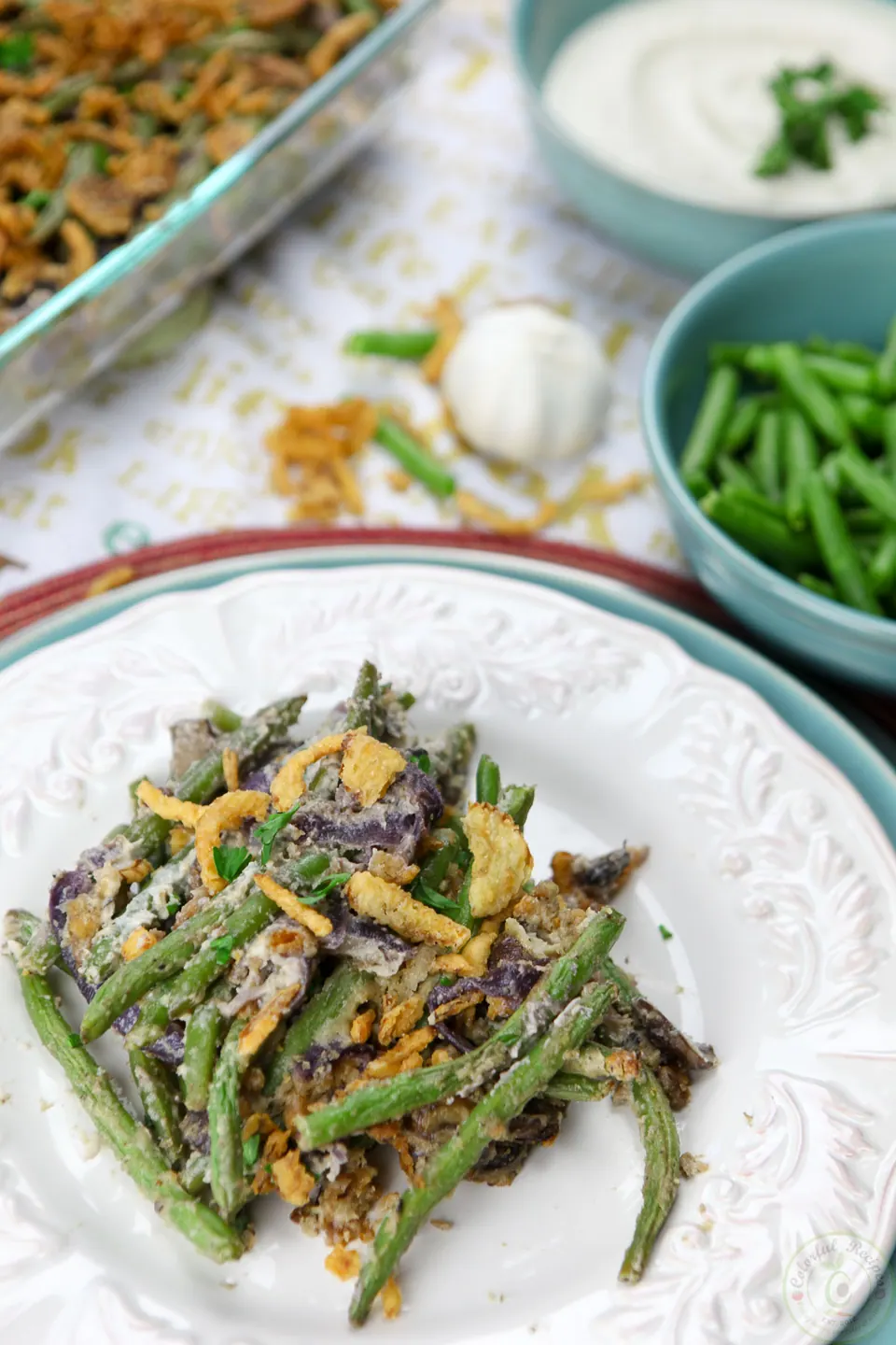 Plate of cashew cream green bean casserole with a bowl of cashew cream