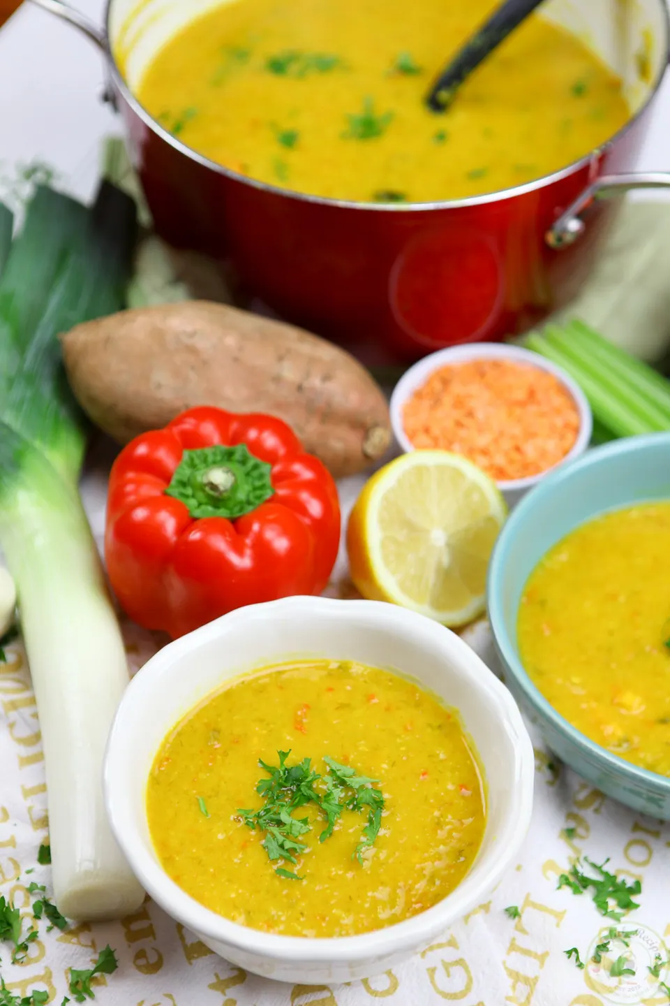 Pot of detox red lentil veggie soup with lemon