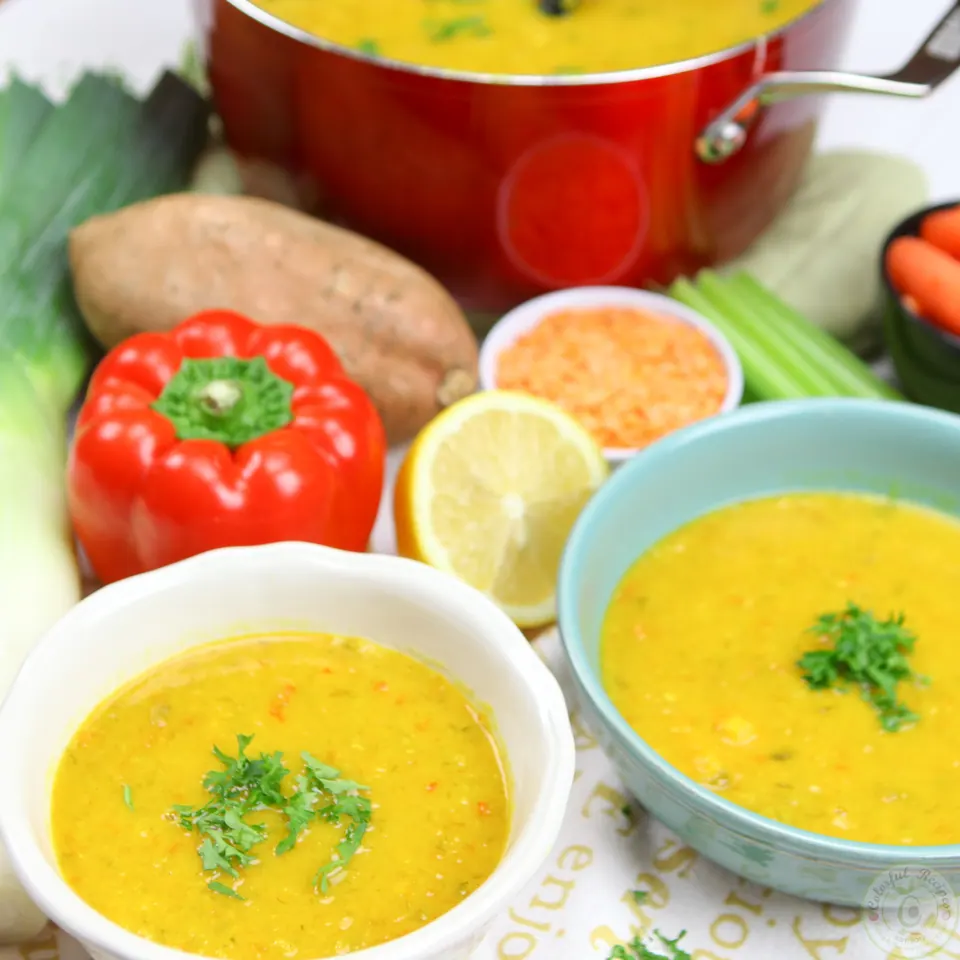 Two bowls of detox red lentil veggie soup ready to serve
