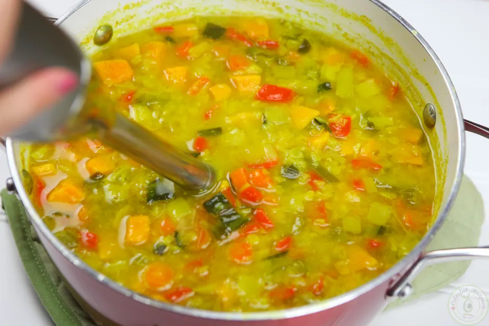 Red lentils simmering with vegetables in water