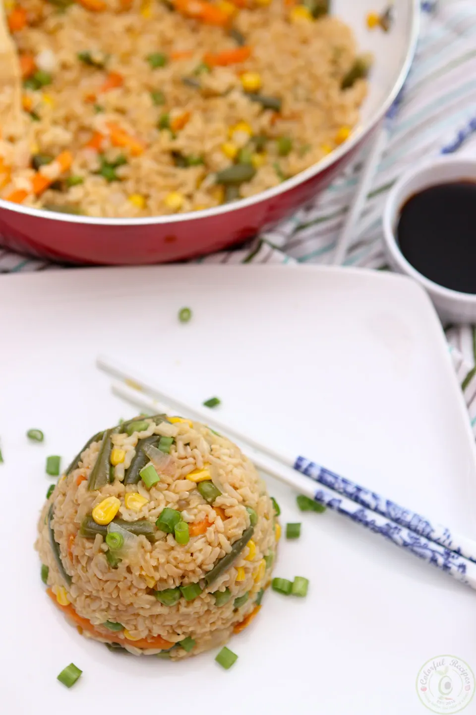 Easy vegan fried rice served with soy sauce and chopsticks