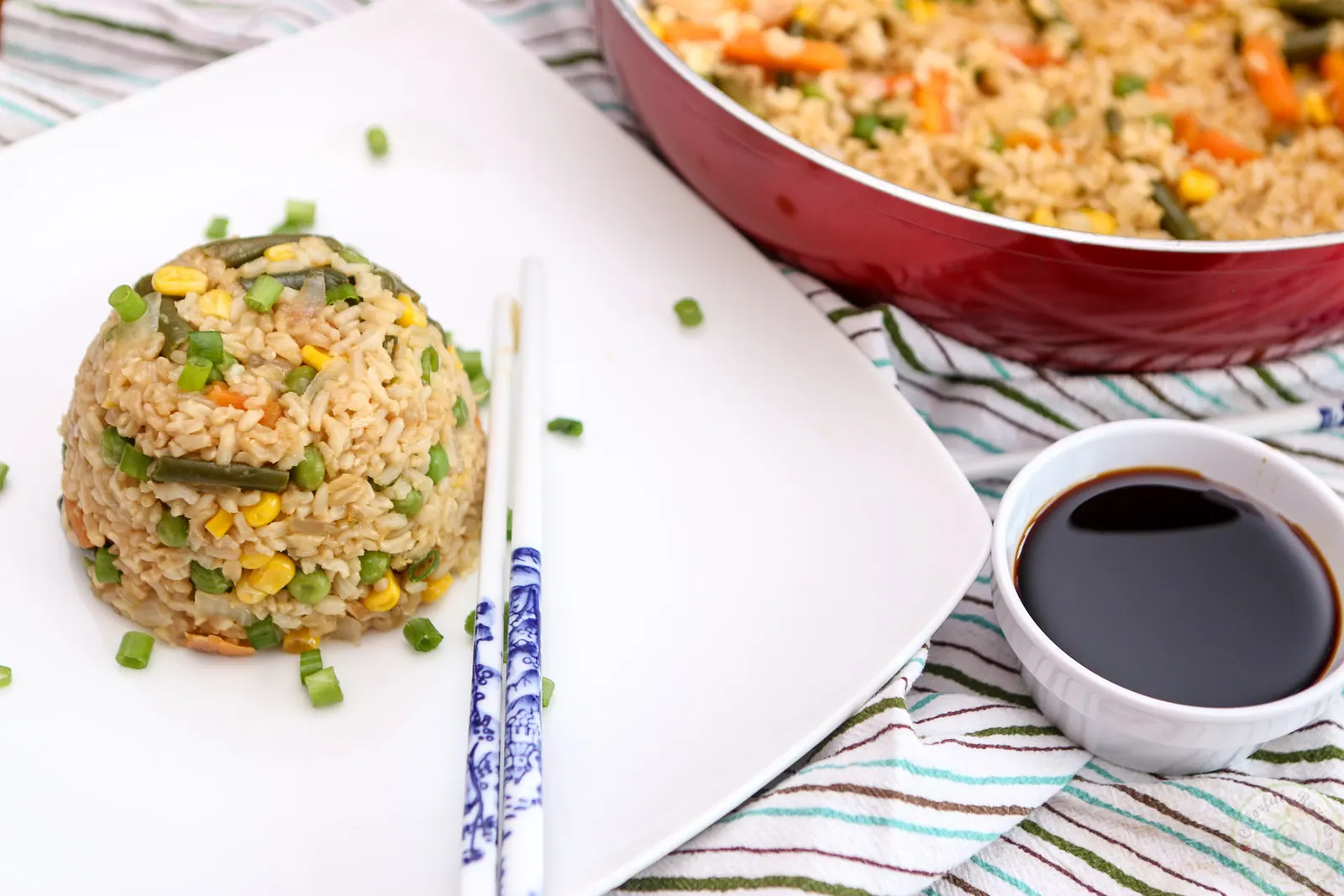 Easy 15 minute vegan fried rice with chopsticks and a dish of soy sauce