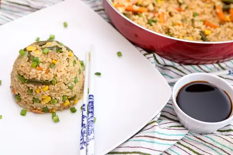 Easy 15 minute vegan fried rice with chopsticks and a dish of soy sauce
