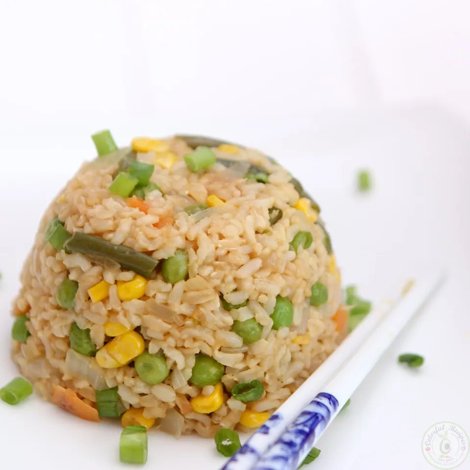 Close-up of vegan fried brown rice with corn, peas and green beans
