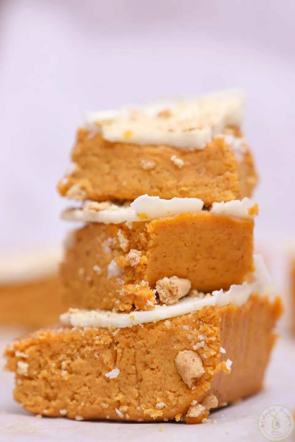 Rows of no bake pumpkin cheesecake bites on parchment