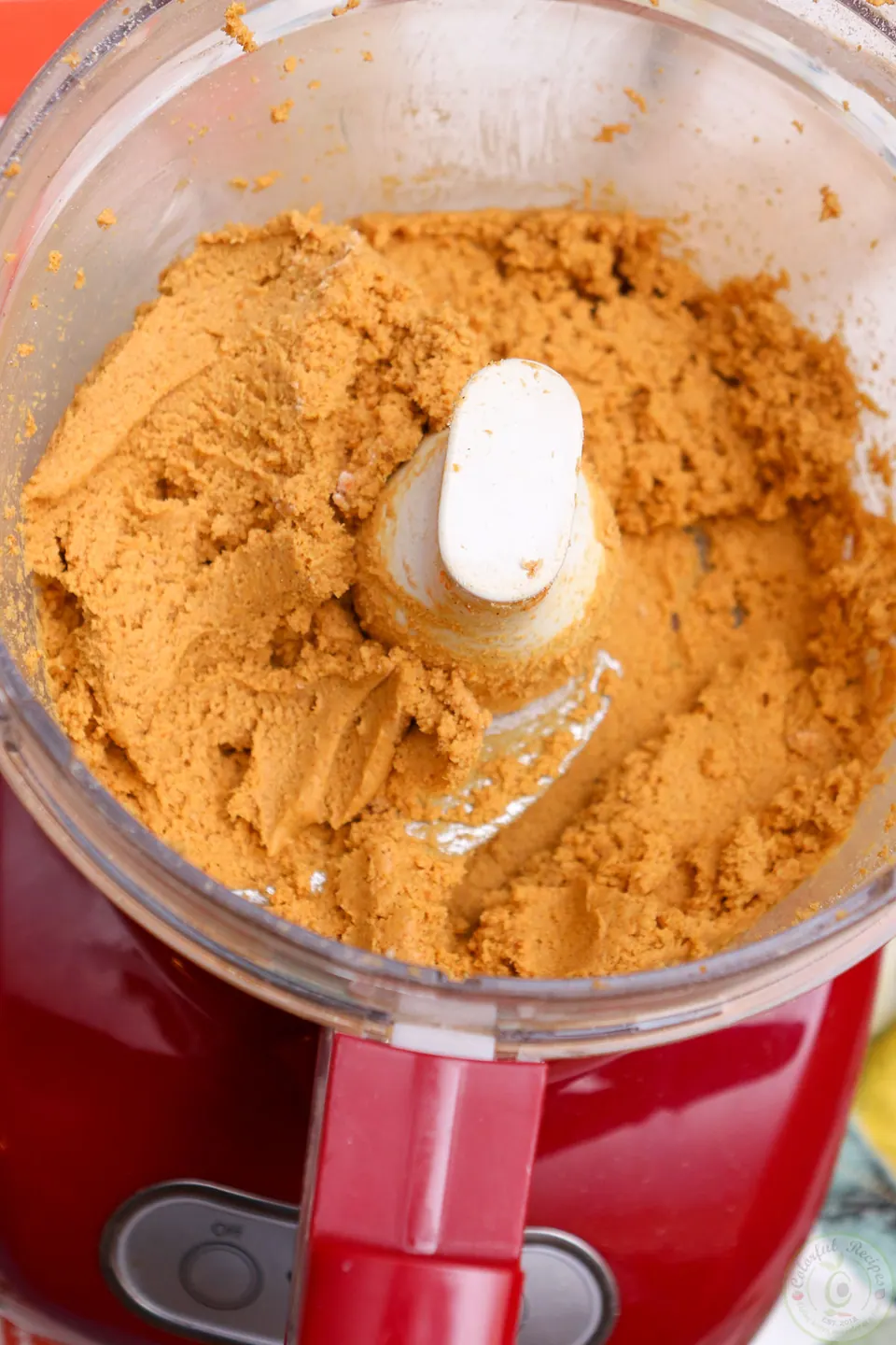 Pinch of no bake pumpkin cheesecake dough held together between fingers