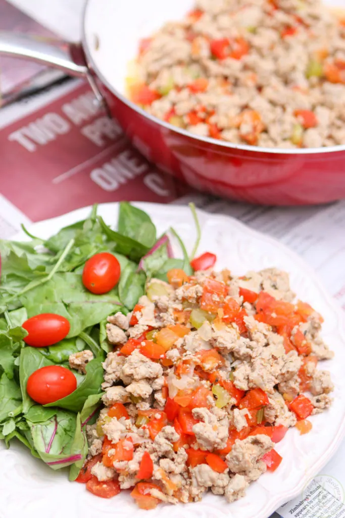 Skillet of organic ground turkey with bell peppers, celery and tomatoes
