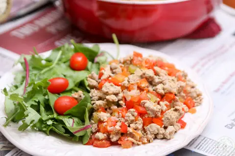 Skillet of organic ground turkey with bell peppers, celery and tomatoes