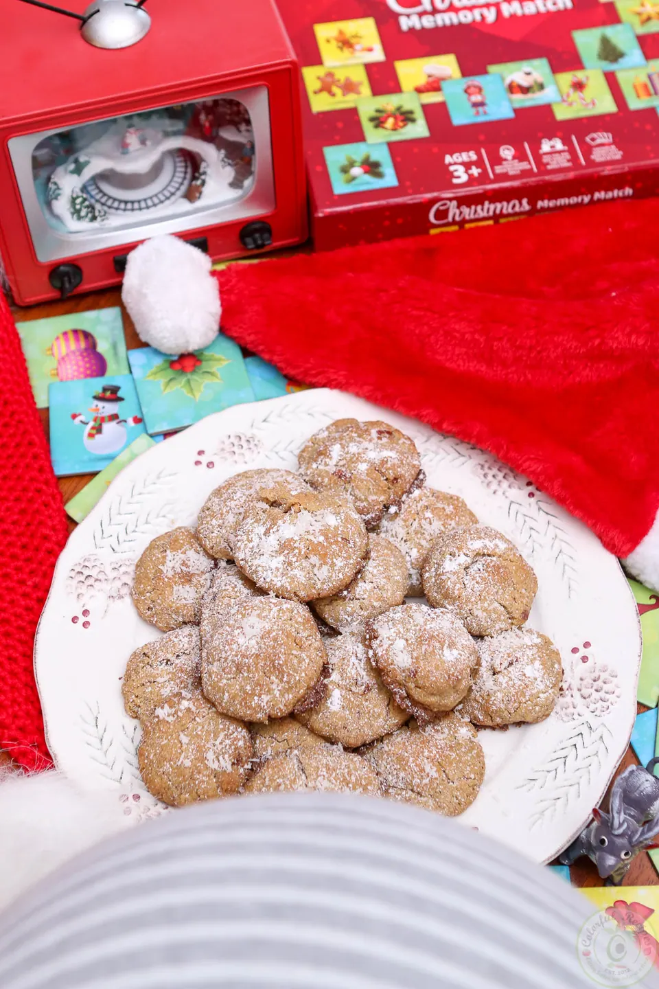 Plate of gluten-free coconut pecan cookies topped with coconut and powdered sugar