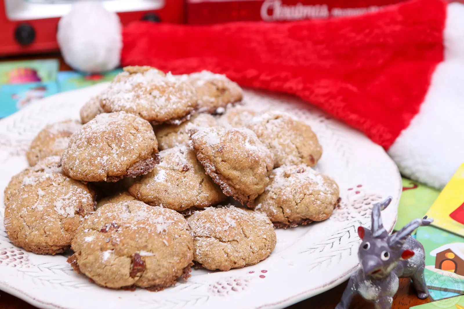 Plate of gluten-free coconut pecan cookies dusted with powdered sugar
