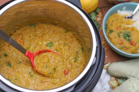 Bowl of buttery Instant Pot pigeon pea dal served over rice