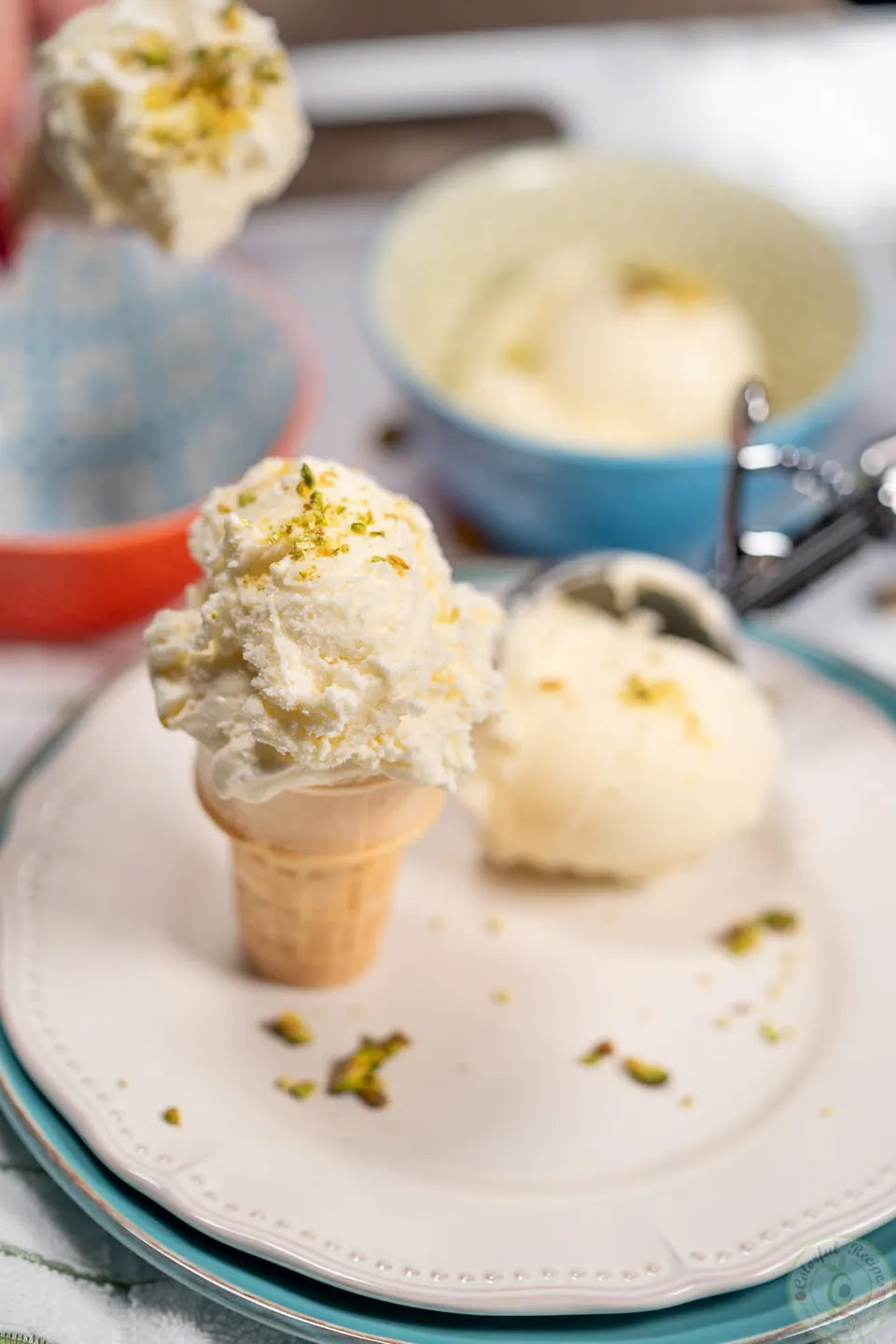 Milk ice cream booza in a cone and in a bowl, garnished with pistachios