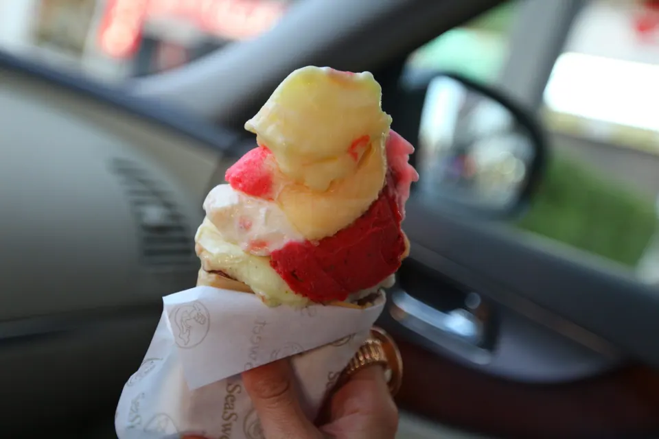 Hand holding Lebanese booza mshakal with colorful ice cream flavors
