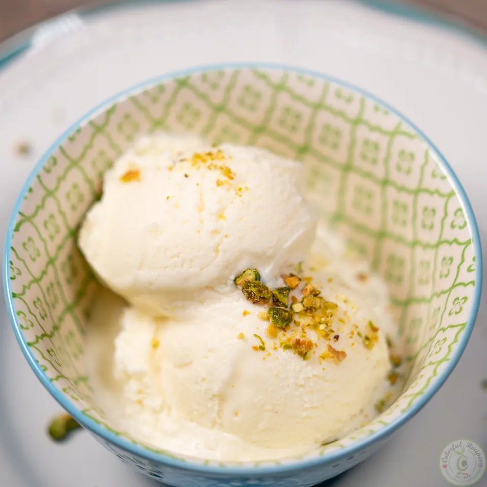 Two scoops of milk ice cream booza topped with crushed pistachios